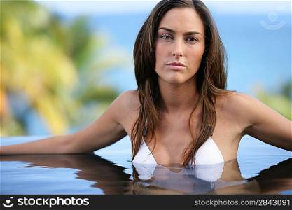 Brunette posing in swimming pool