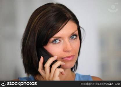 Brunette posing whilst on the telephone