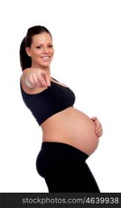 Brunette pregnant in black pointing at camera isolated on a white background