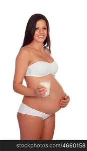 Brunette pregnant in underwear with glass milk isolated on a white background