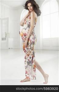 Brunette pregnant lady wearing flowered dress