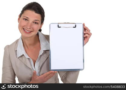 Brunette presenting blank clip-board