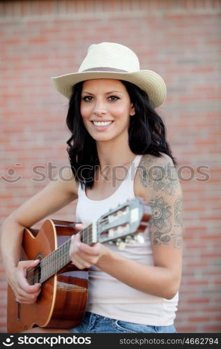 Brunette pretty woman playing a clasic guitar