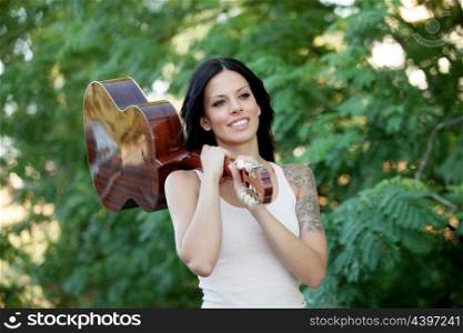 Brunette pretty woman with a clasic guitar