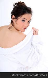 Brunette seductively removing bath robe