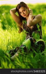 brunette sitting on green grass