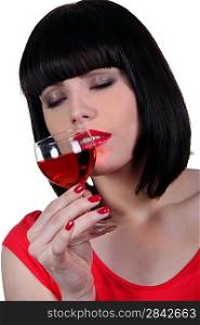 Brunette smelling glass of wine