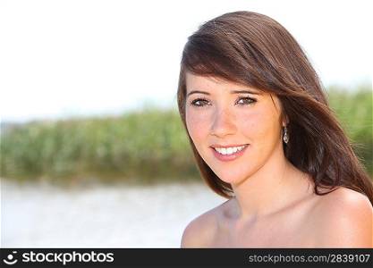 Brunette stood by a lake