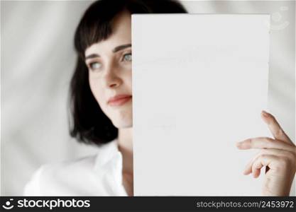 brunette student girl with books moke up, reads or keeps in a white shirt, studio isolated portrait emotions.. brunette student girl with books moke up, reads or keeps in a white shirt, studio isolated portrait emotions