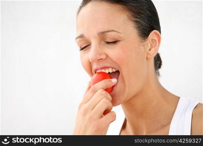 Brunette taking a bite out of an apple