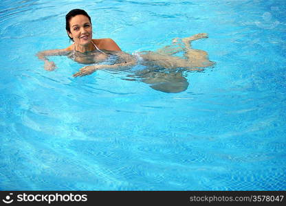 Brunette taking a dip in the pool