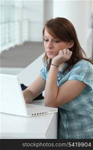 Brunette teenager concentrating on computer screen