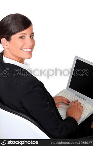 Brunette typing on laptop keyboard