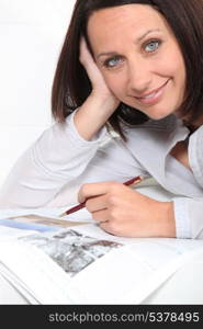 Brunette using a pen