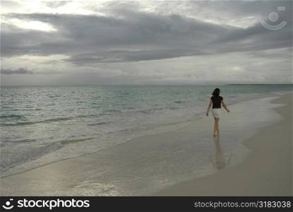 Brunette walking on the beach