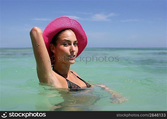 Brunette wearing hat and swimming