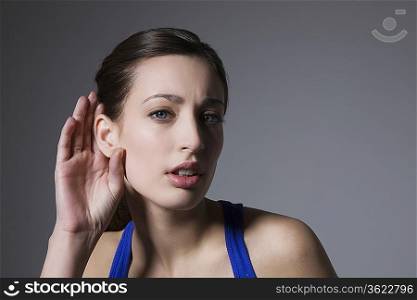 Brunette with hand behind ear