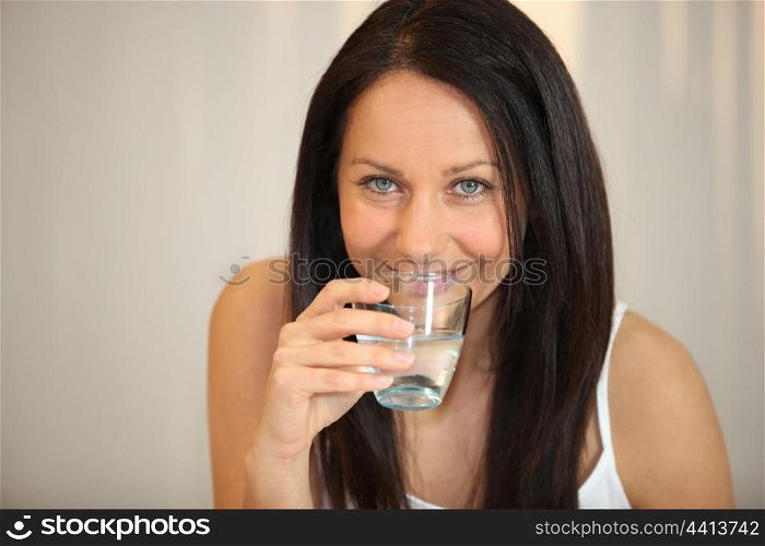 brunette woman drinking water