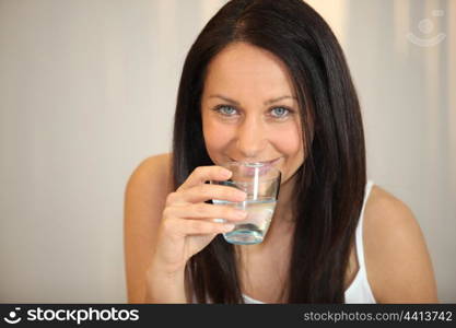 brunette woman drinking water