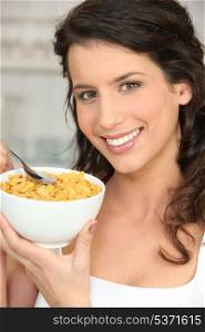 Brunette woman eating cereal