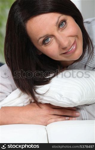 brunette woman holding cushion