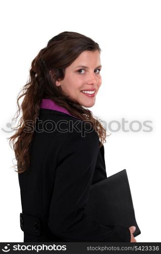 Brunette woman holding folder under arm