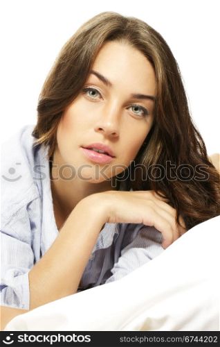brunette woman in bed. brunette woman in bed on white background