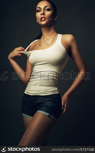 brunette woman in shorts and white top