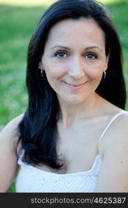 Brunette woman looking at camera on a flowered meadow