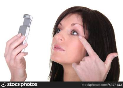 Brunette woman looking at mobile phone screen