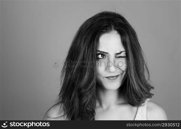 brunette woman making faces. black and white portrait of a beautiful brunette woman making faces