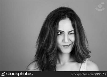 brunette woman making faces. black and white portrait of a beautiful brunette woman making faces