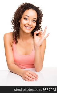 Brunette woman smiling while doing ok sign