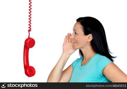 Brunette woman speaking through a phone hanging