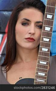 Brunette woman with a guitar neck
