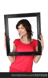 Brunette woman with black picture frame