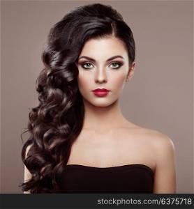 Brunette Woman with Curly Hairstyle. Beautiful Girl with long Wavy Hair. Perfect Makeup. Fashion photo