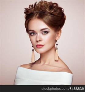 Brunette Woman with Elegant and shiny Hairstyle. Beautiful Model Woman with Curly Hairstyle. Care and Beauty Hair products. Perfect Make-Up