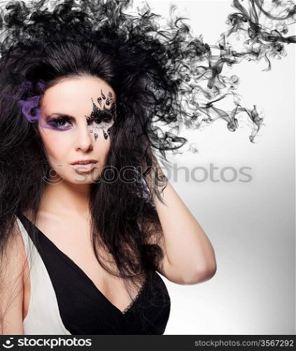 Brunette woman with face art and smoke