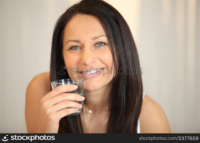 Brunette woman with glass of water