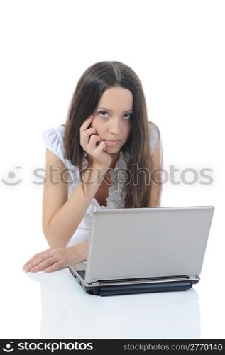 Brunette woman with laptop lying on the floor. Isolated on white background
