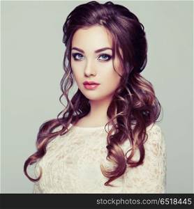 Brunette woman with long and shiny curly hair. Brunette Woman with Long and shiny Curly Hair. Beautiful Model Lady with Curly Hairstyle. Care and Beauty Hair products. Care and Beauty of Hair