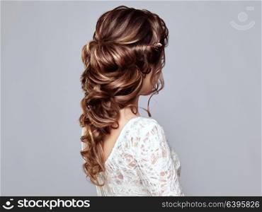 Brunette Woman with Long and shiny Curly Hair. Beautiful Model Lady with Curly Hairstyle. Care and Beauty Hair products. Care and Beauty of Hair