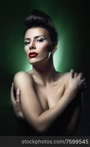 brunette woman with red lips in dark green light