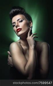 brunette woman with red lips in green light