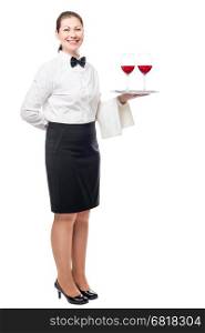 brunette woman working as a waiter, holding a tray of glasses of wine isolated in a studio