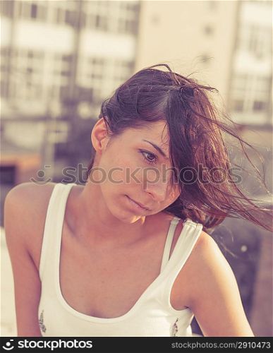 brunette women on the roof of the building, vintage toned image, summertime freedom concept