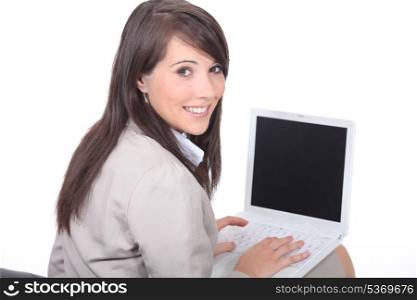 Brunette working on laptop computer