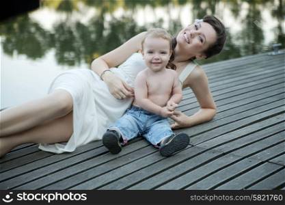 Brunette young mother posing with her son