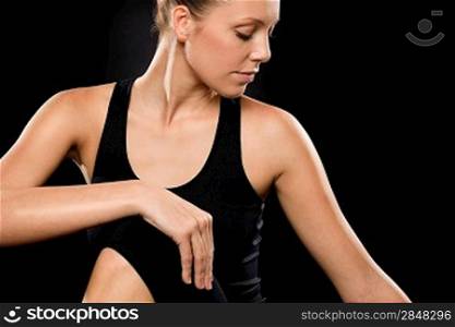 Brunette young woman in spine twisting pose performing yoga exercise